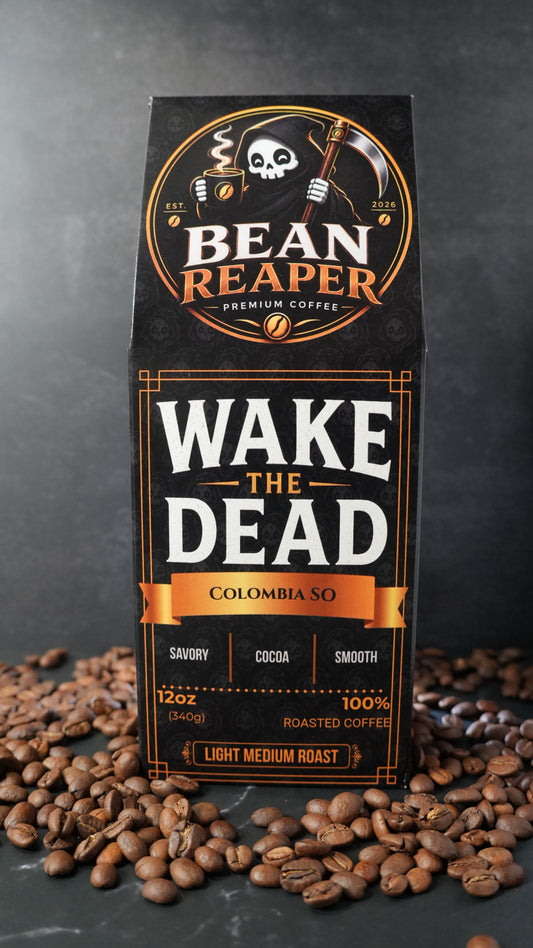 Bean Reaper Wake The Dead coffee bag front — Colombia single origin, 12 oz light-medium roast, standing on whole coffee beans