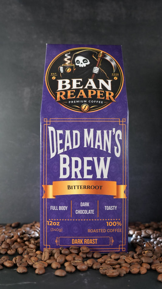 Bean Reaper Dead Man's Brew coffee bag front — Bitterroot, 12 oz dark roast, standing on whole coffee beans