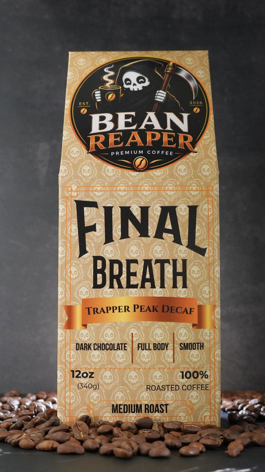 Bean Reaper Final Breath decaf coffee bag front — Trapper Peak Decaf, 12 oz medium roast, standing on whole coffee beans